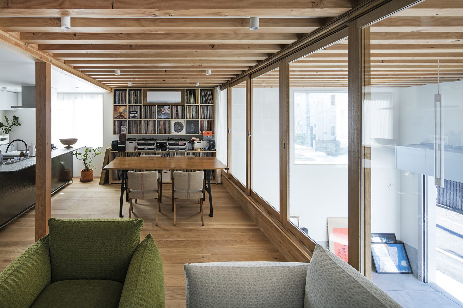 A timber-framed listening room with vinyl record library and an oak dining table